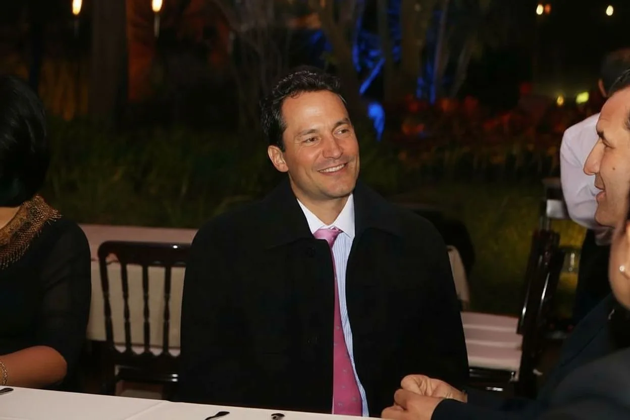 Jorge Velasquez listening to a client over dinner
